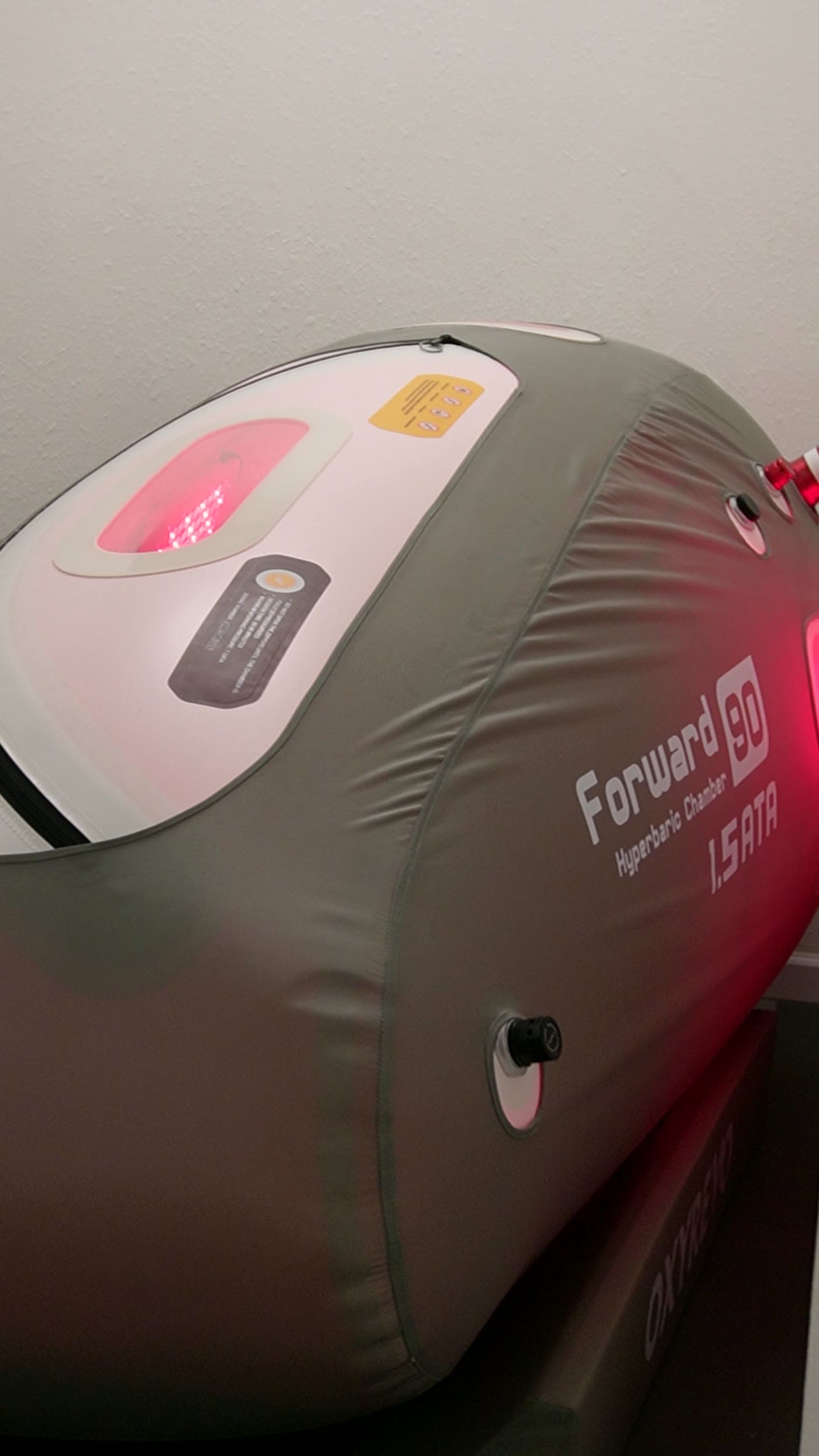Hyperbaric oxygen chamber at SK Longevity with red light detail.