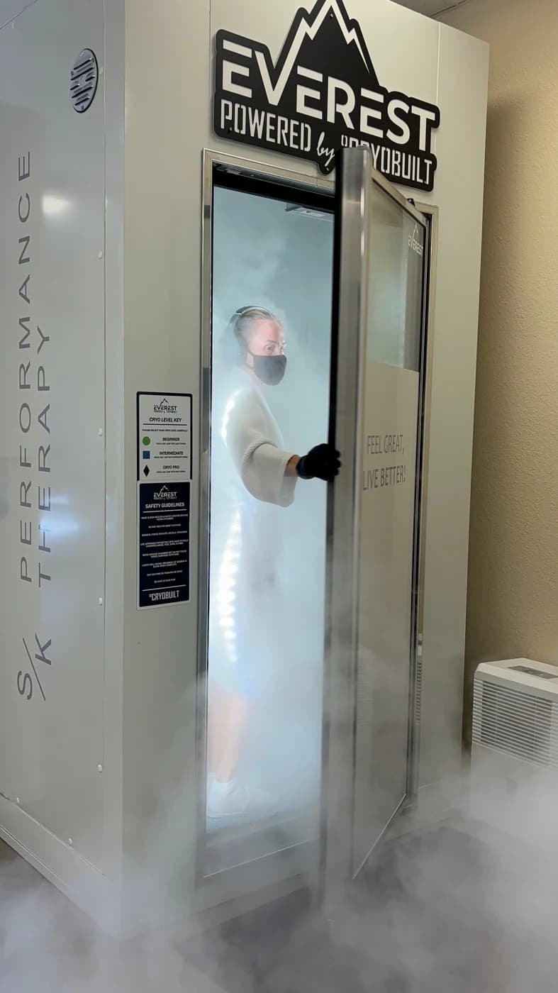 SK Longevity whole-body cryotherapy chamber with cold vapor and client inside.