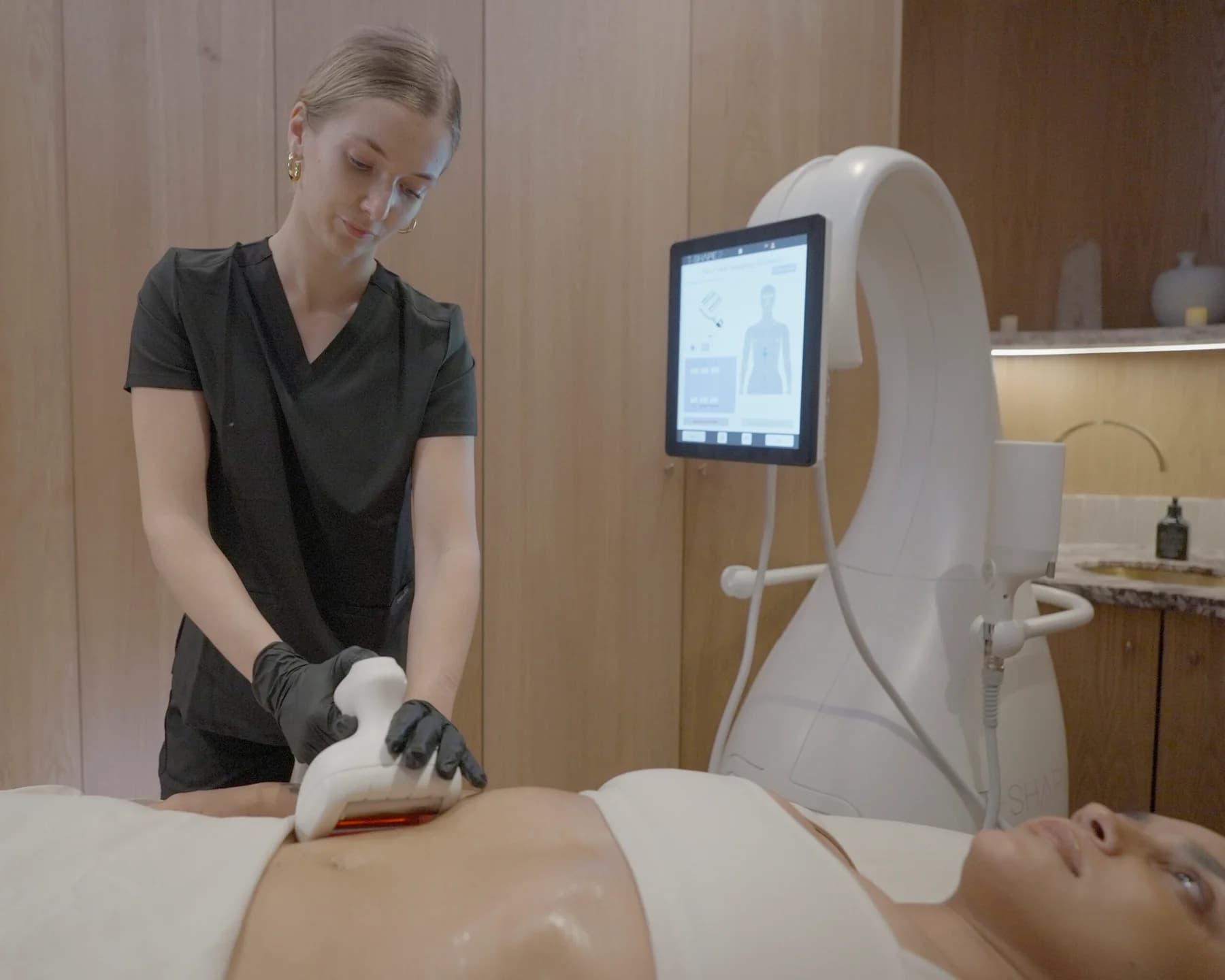 T-Shape body contouring treatment with provider, applicator, and treatment device.