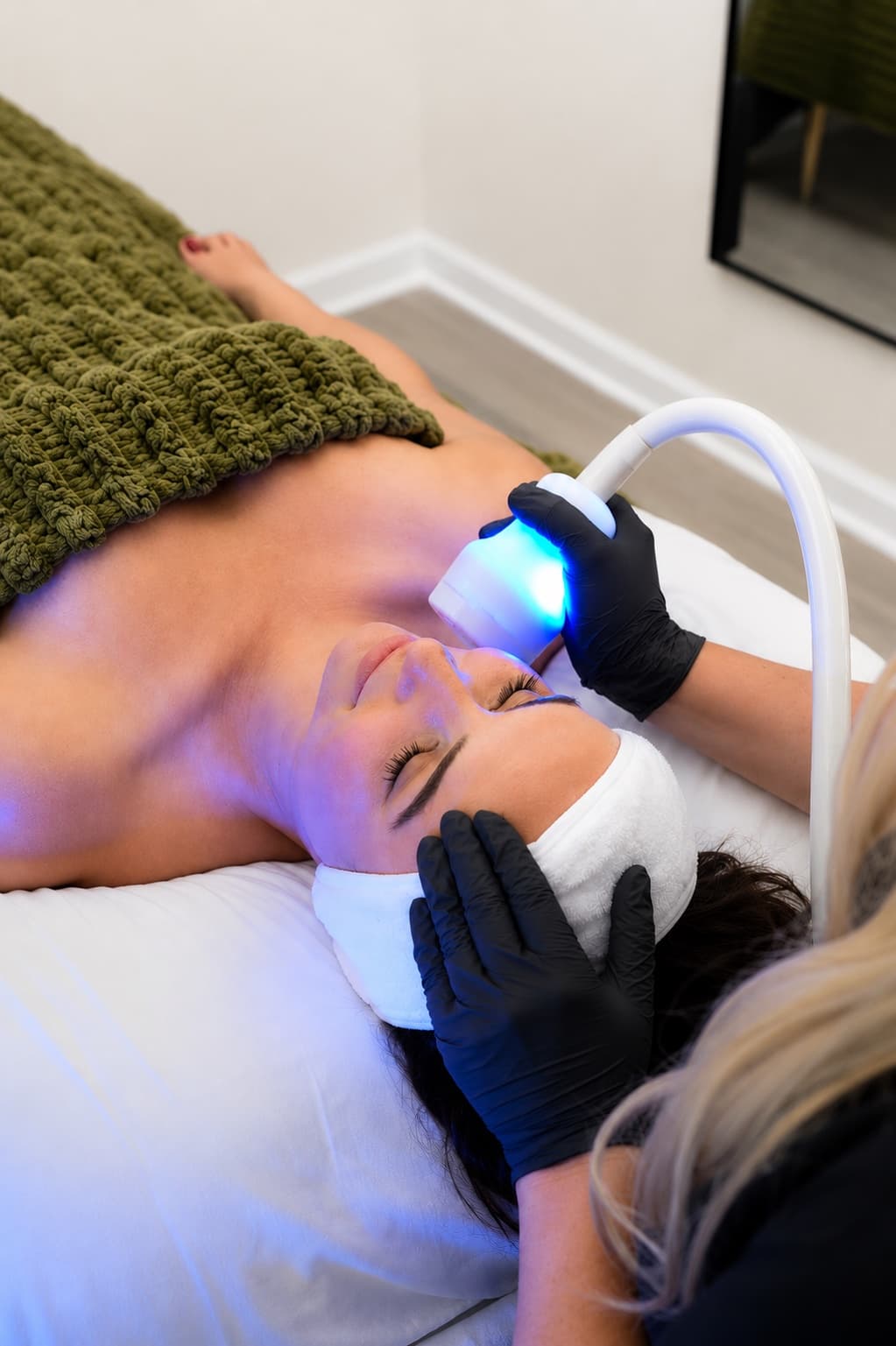 CryoSkin facial treatment with cooling applicator around the client's cheek and jawline.